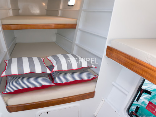 The three berths cabin. In total the catamaran has two double cabins, a triple cabin and two bathrooms. The skipper’s cabin and bathroom are apart. The three berths cabin. In total the catamaran has two double cabins, a triple cabin and two bathrooms. The skipper’s cabin and bathroom are apart.